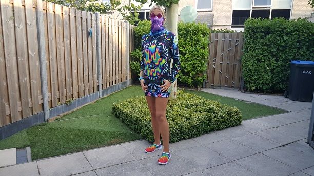 A woman is modeling the women's rave clothing, hoodie dress, and shoes, in landscape orientation.