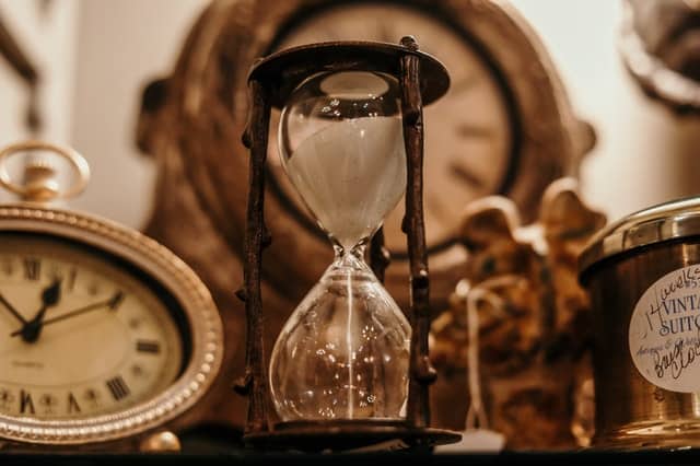An hourglass and clocks