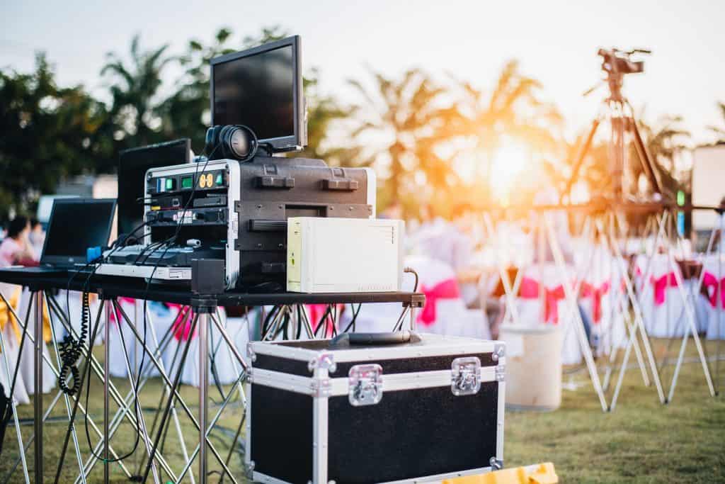 DJ mixing equalizer at outdoor in music party festival with party dinner table
