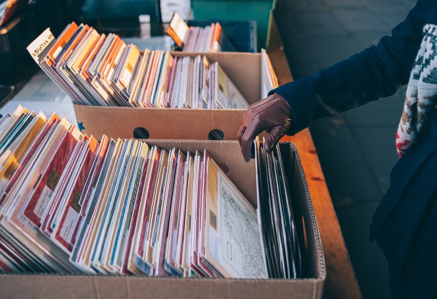 A person is looking through a vinyl music collection